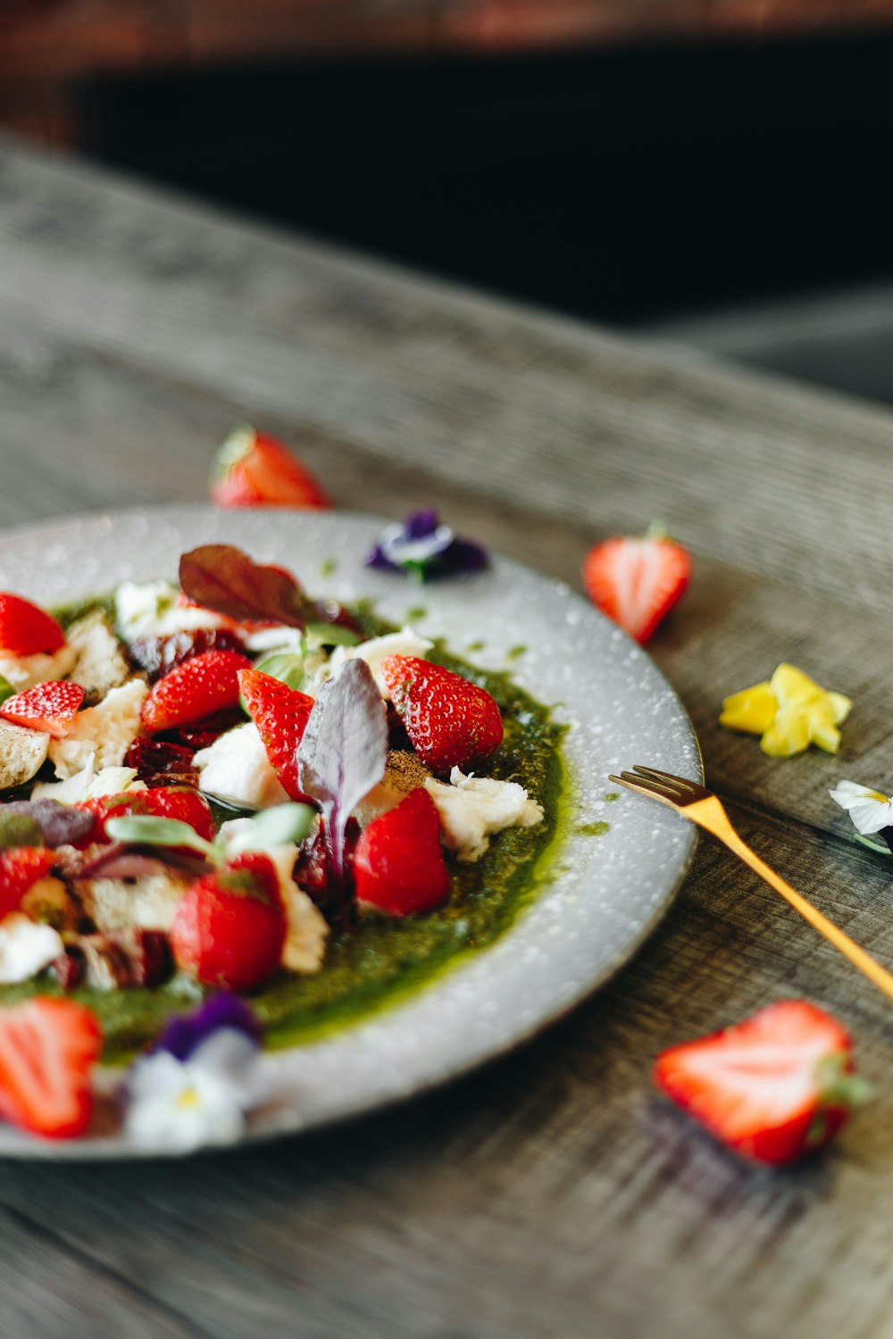 sliced strawberries on green ceramic plate