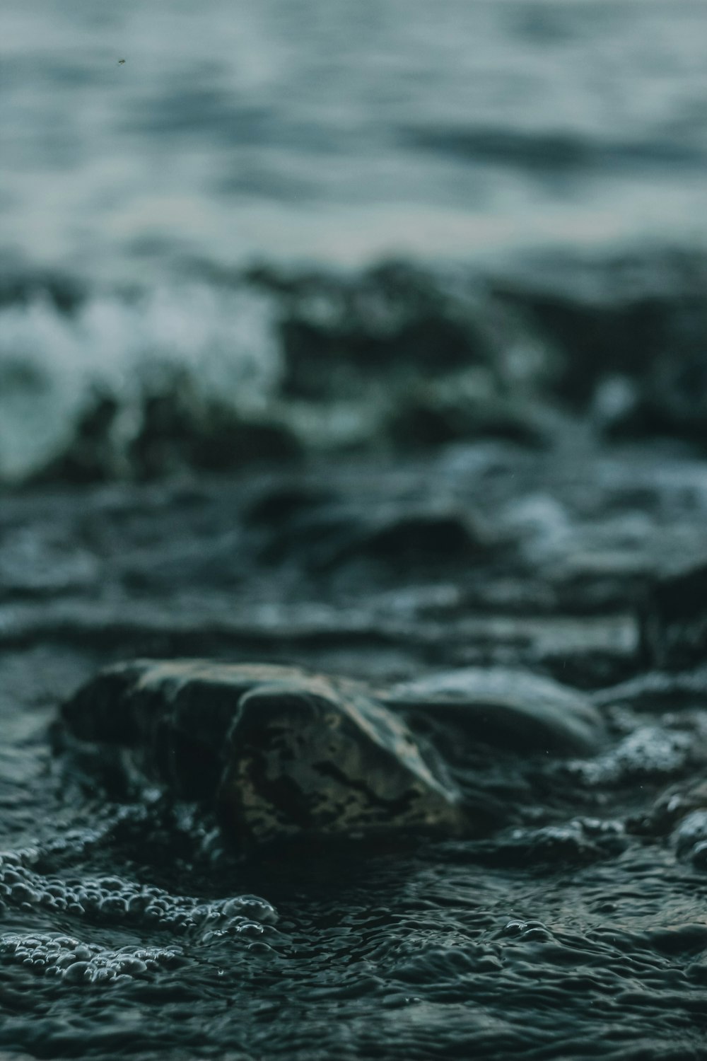 water waves on rocky shore during daytime