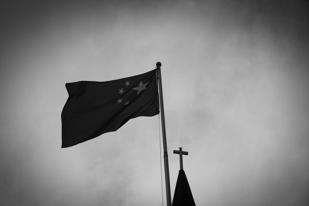 blue flag on pole under cloudy sky