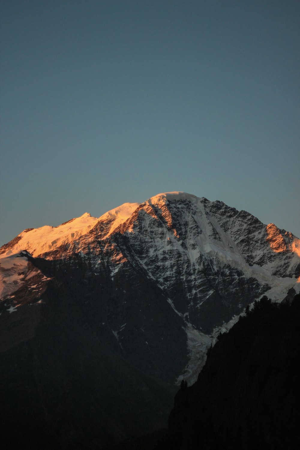 snow covered mountain under blue sky during daytime