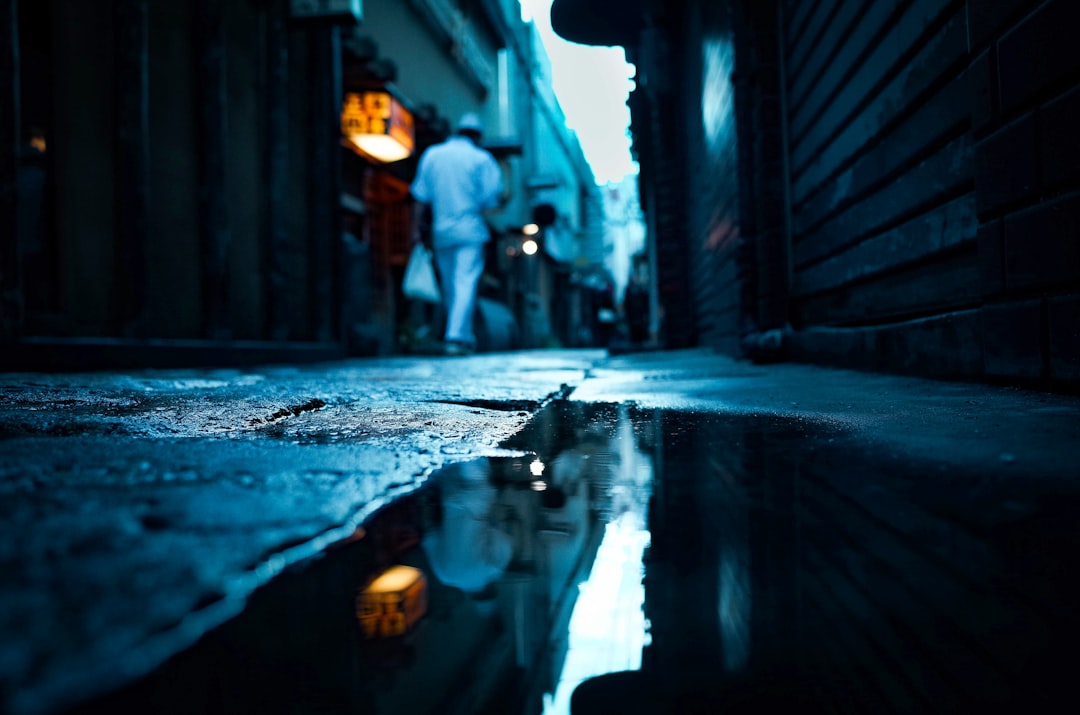 man in black jacket walking on street during daytime