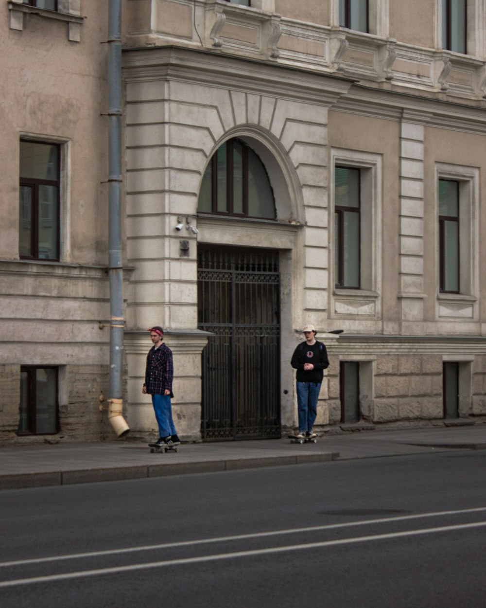 man in blue jacket walking on sidewalk during daytime