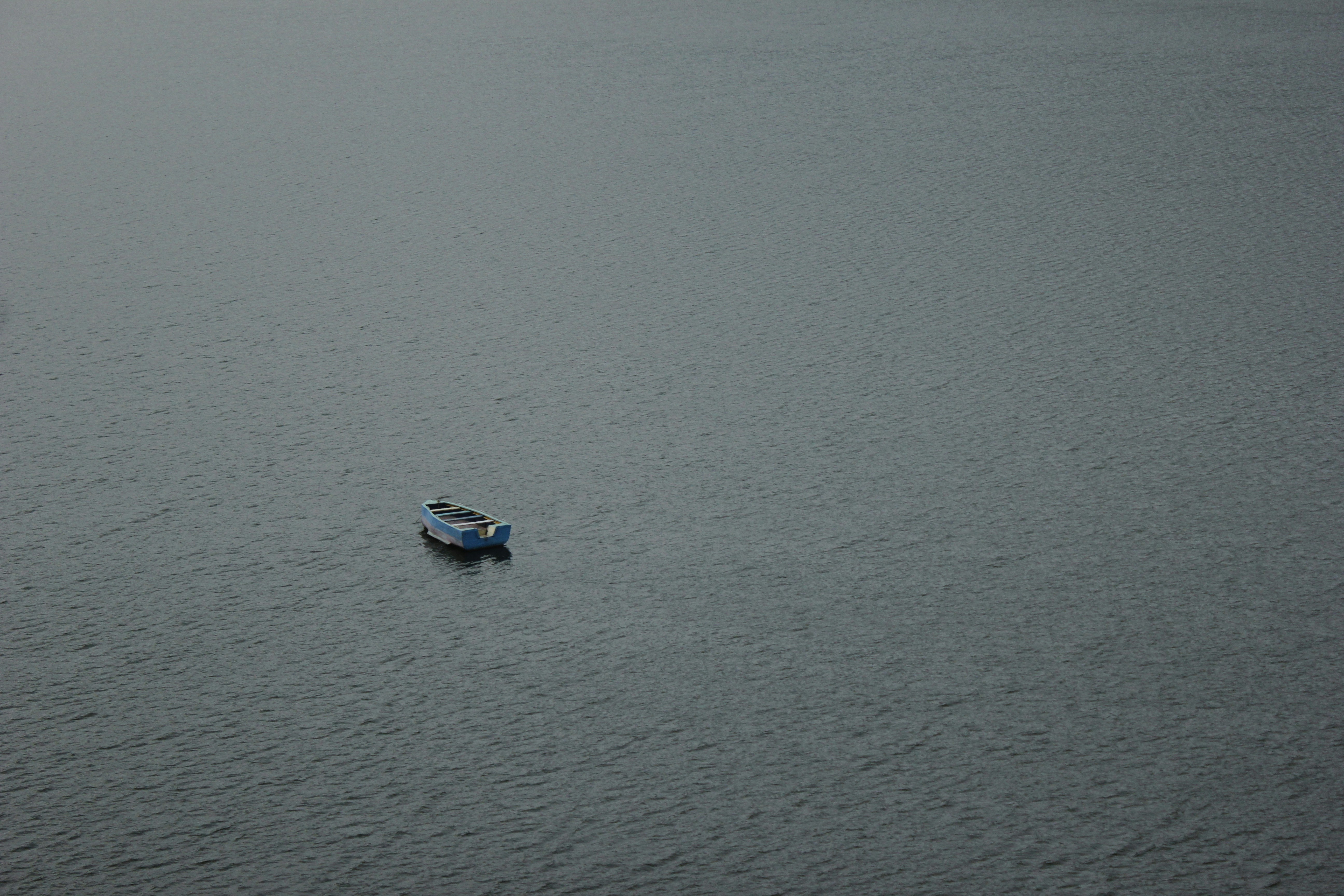 white and blue boat on sea during daytime