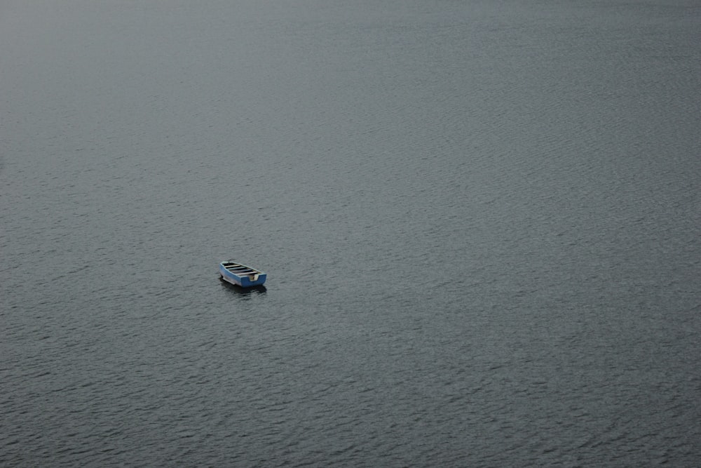 white and blue boat on sea during daytime