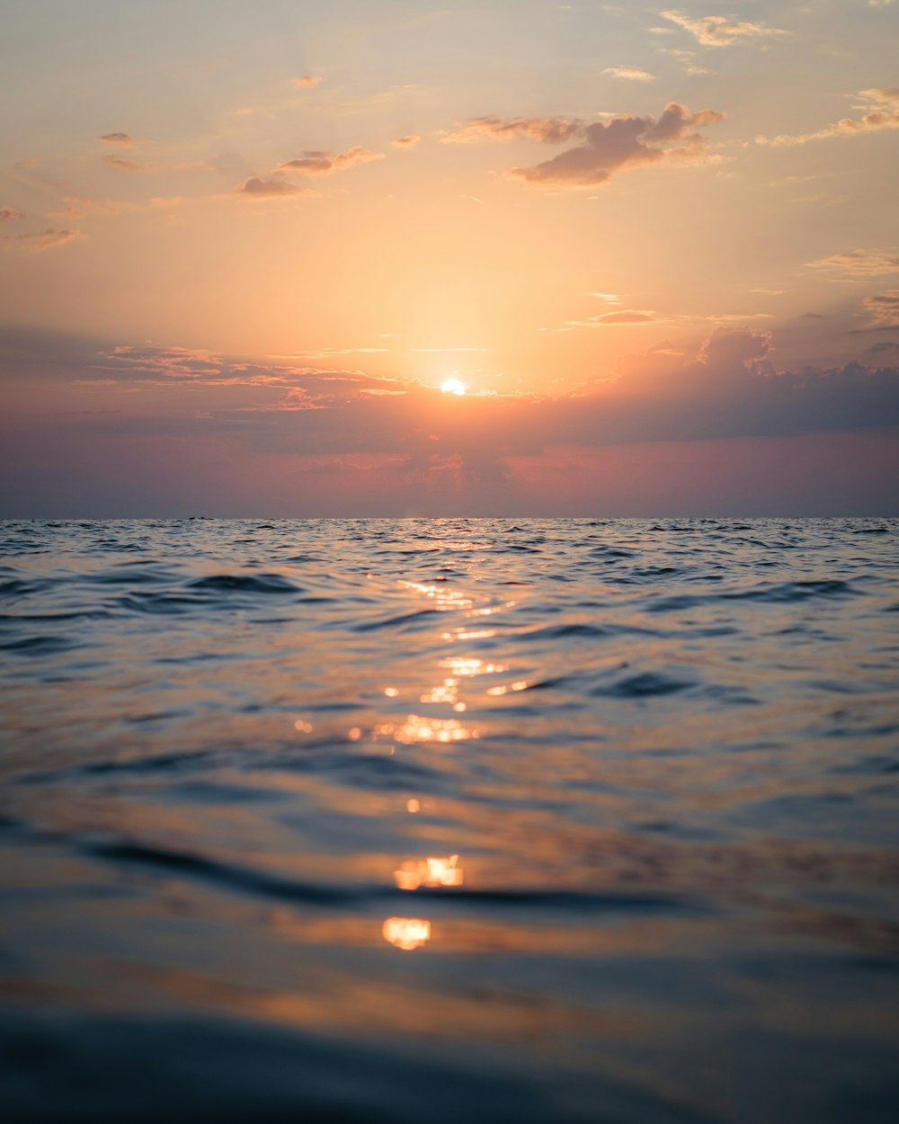 body of water during sunset