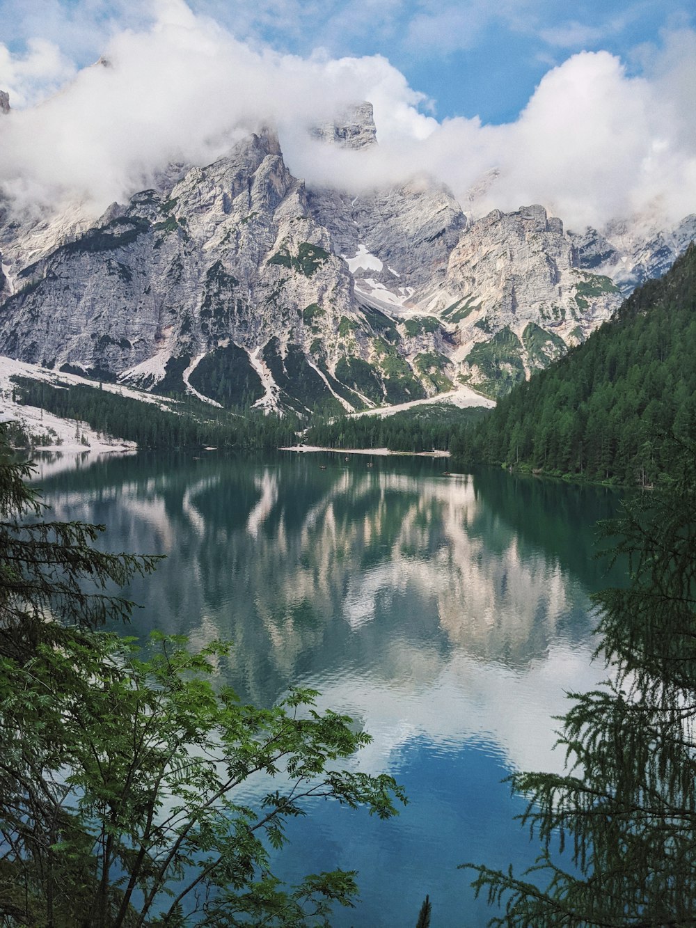 Lake surrounded by green trees and snow covered mountain during daytime  photo – Free Water Image on Unsplash
