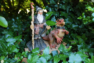 A fantasy adventure game scene with a hero facing a dragon in a mystical forest.