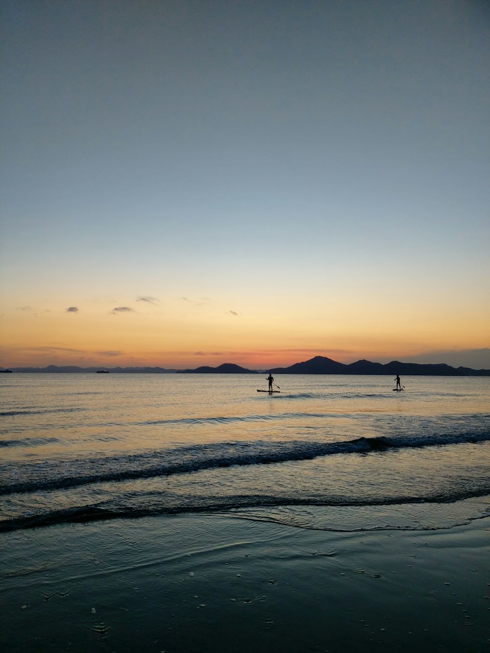 silhouette of people on beach during sunset