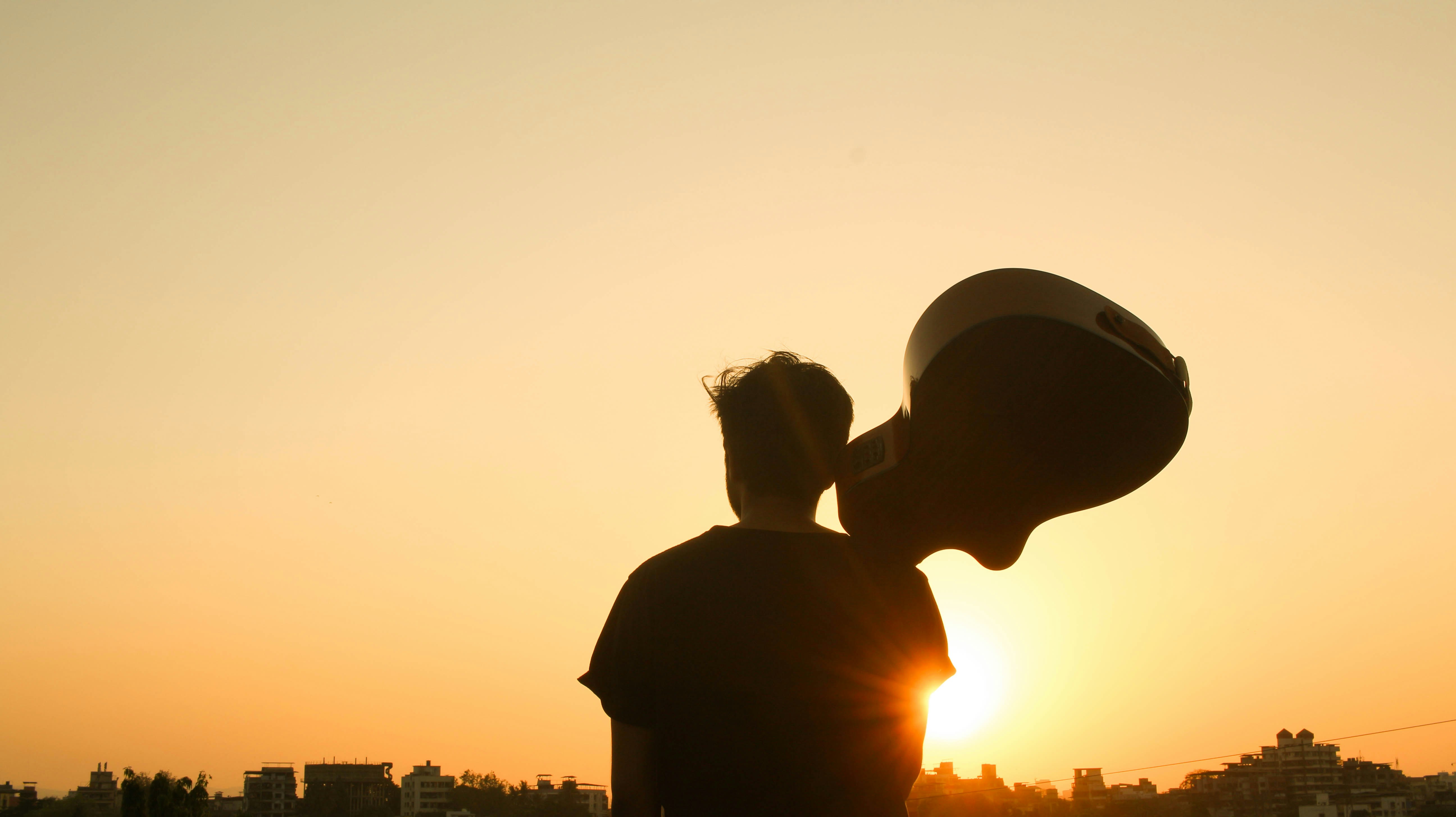 Guitar player silhouette at sunset