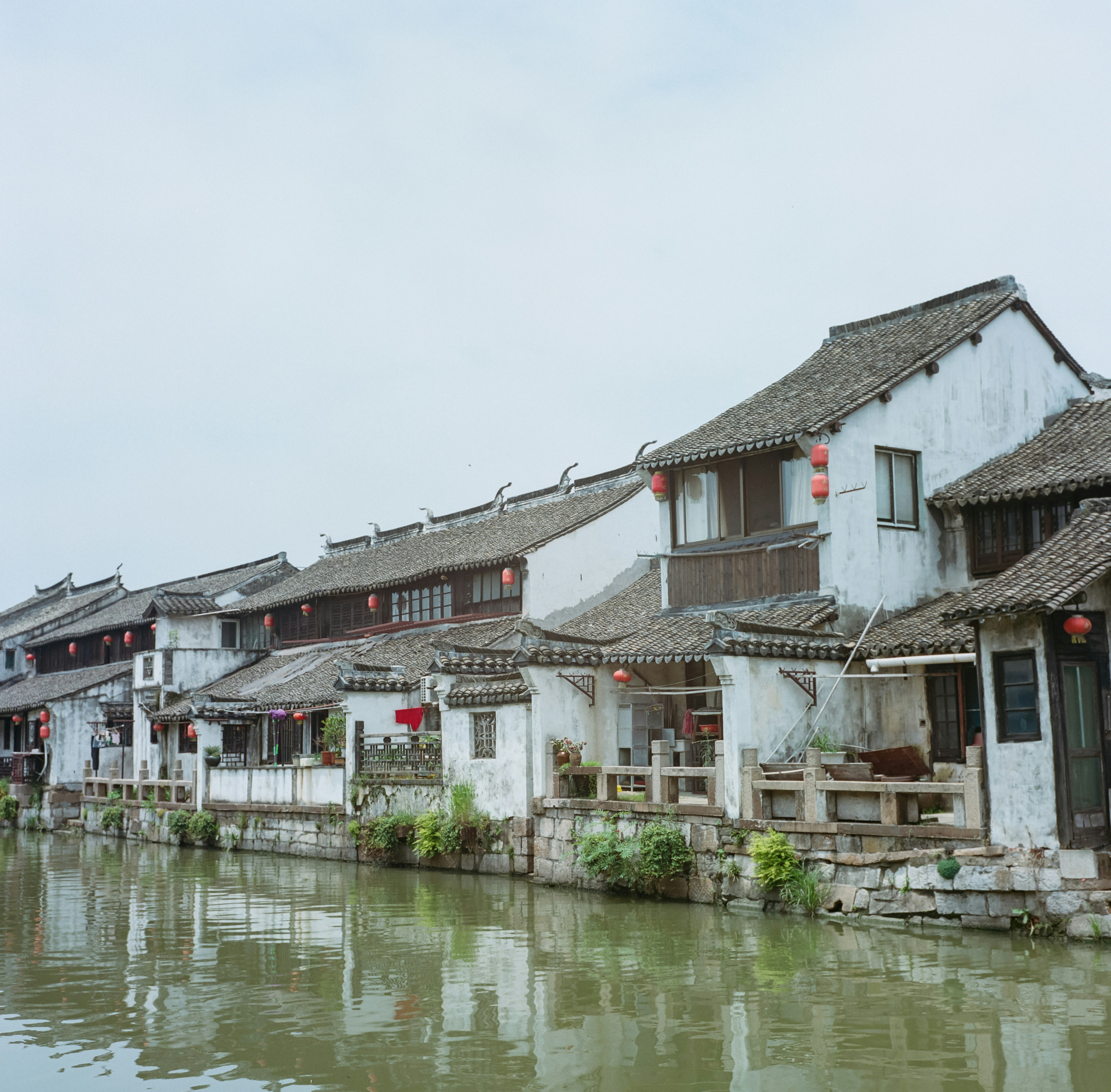 white and brown concrete building beside body of water during daytimeby Derek Lee