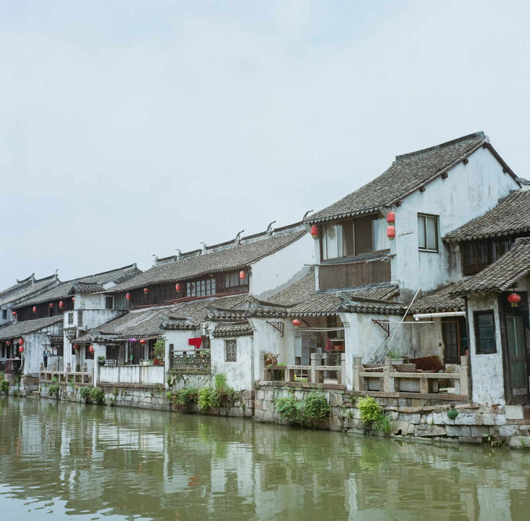 white and brown concrete building beside body of water during daytime