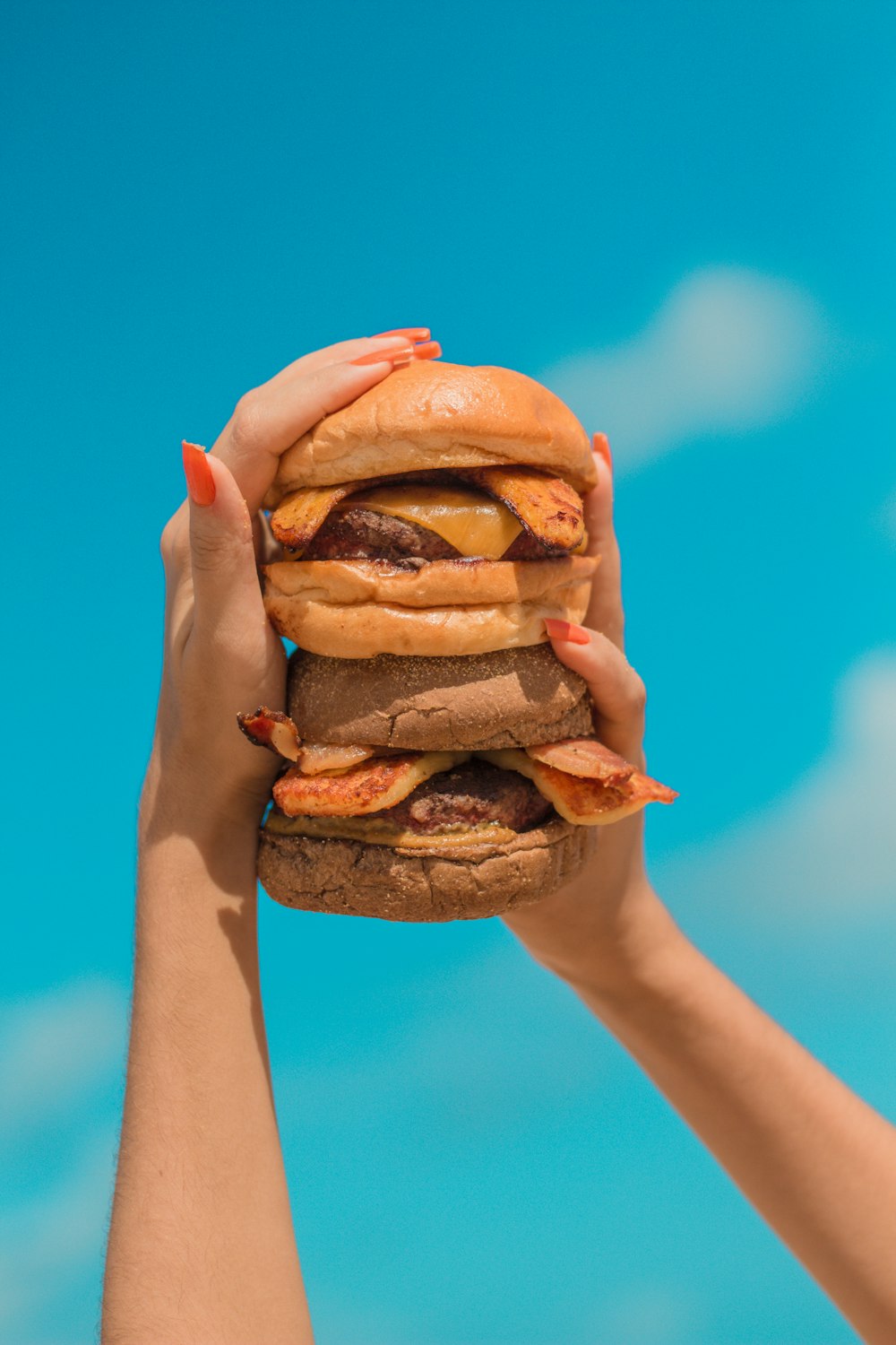 person holding burger with patty