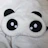 Close-up of a silk eye mask resting on a soft pillow.