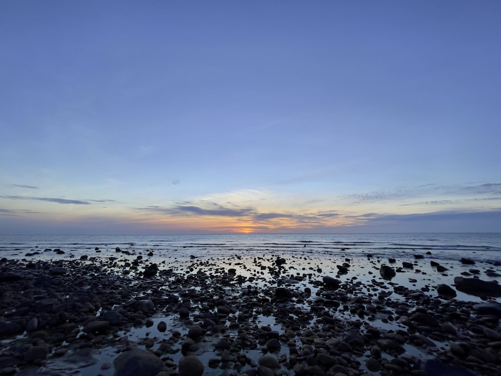 body of water under blue sky during daytime