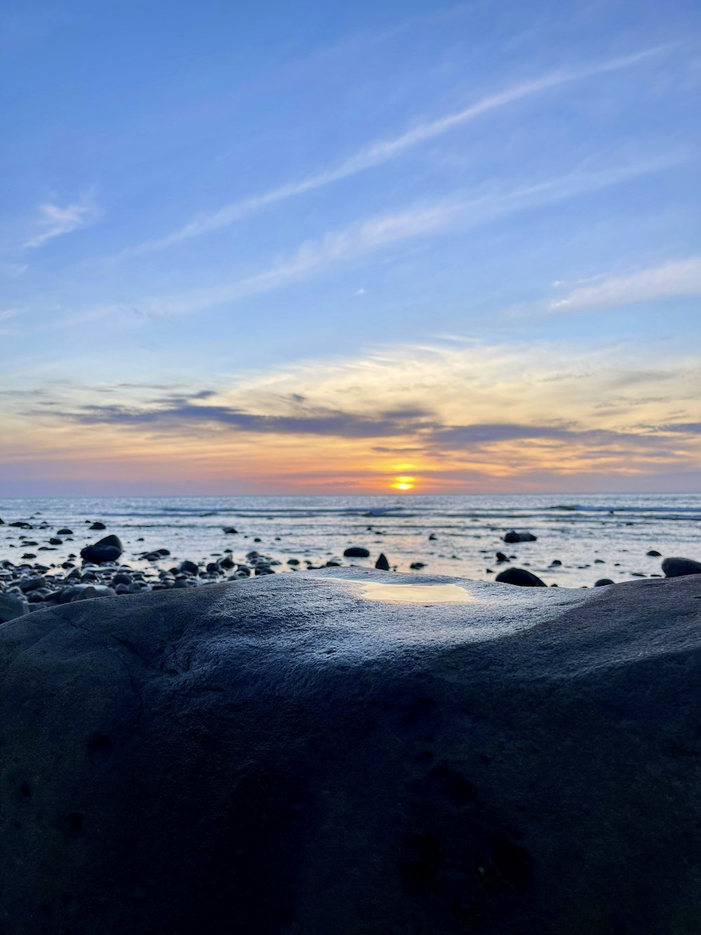 sea waves crashing on shore during sunset