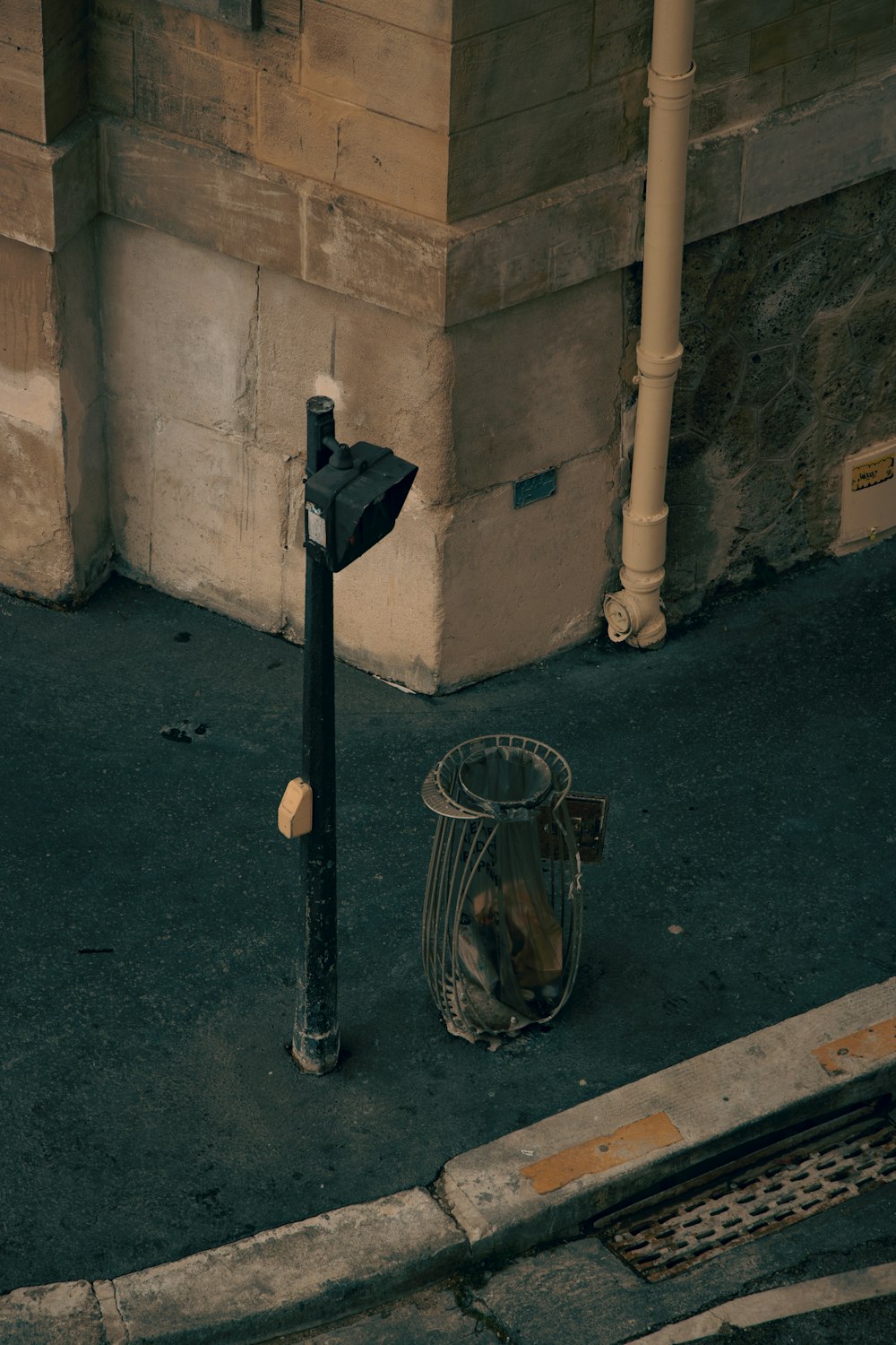 black metal lamp post beside brown concrete wall