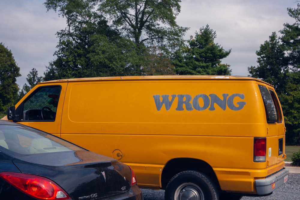 yellow van parked near green trees during daytime