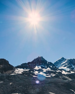 A picturesque mountain landscape under a bright sun.