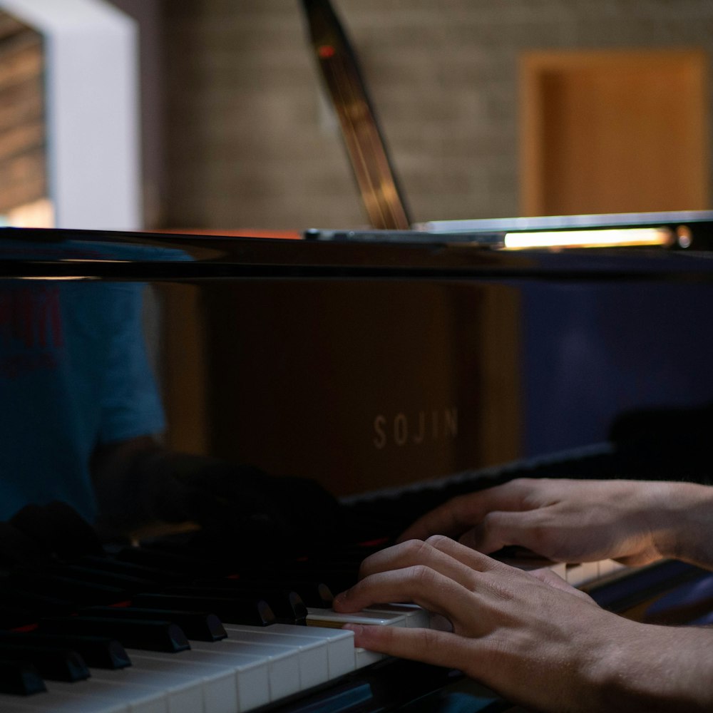 person playing black and white piano