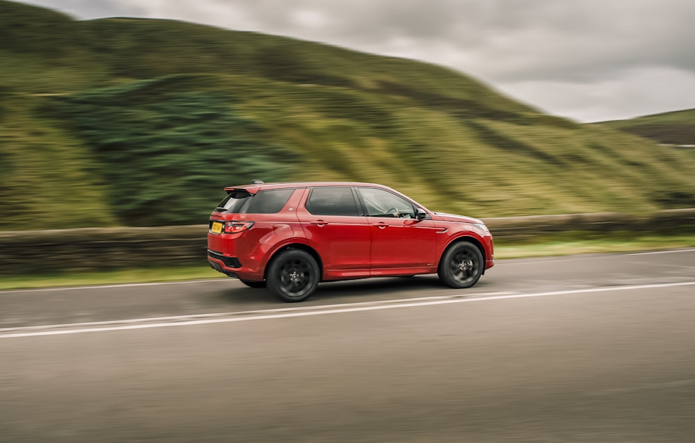 red suv on road during daytime