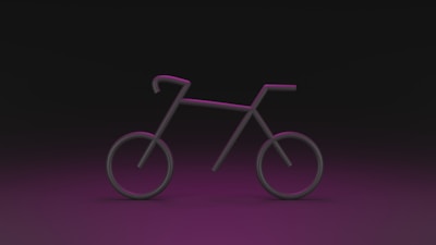A stylized and minimalistic outline of a bicycle with neon pink lighting against a dark background. The bicycle shape is created using simple lines and circles, giving it a futuristic appearance.