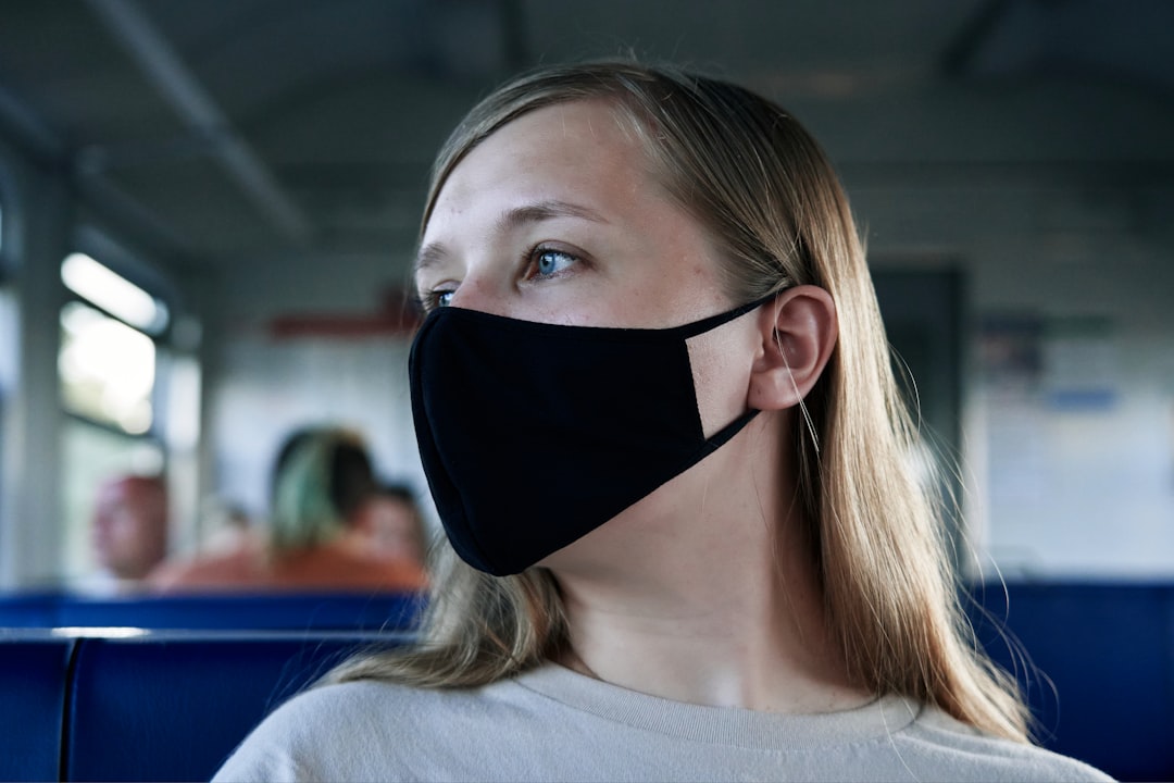 woman in white crew neck shirt wearing black eye mask