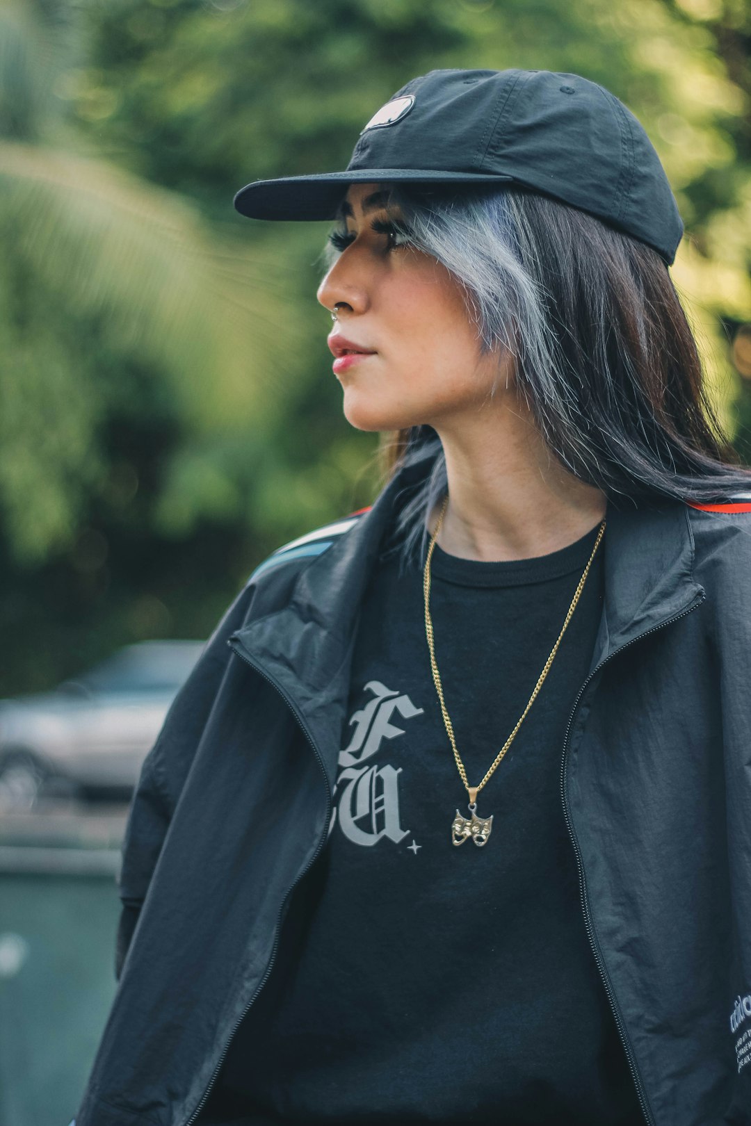 woman in black leather jacket wearing black cap