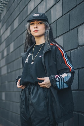 woman in black and white adidas zip up jacket and black skirt