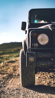 black jeep wrangler on green grass field during daytime