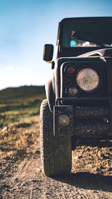 black jeep wrangler on green grass field during daytime