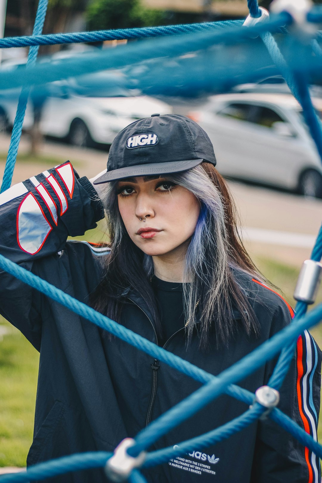 woman in black jacket wearing black and white fitted cap