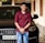 man in red button up shirt and blue denim jeans sitting on black mercedes benz car