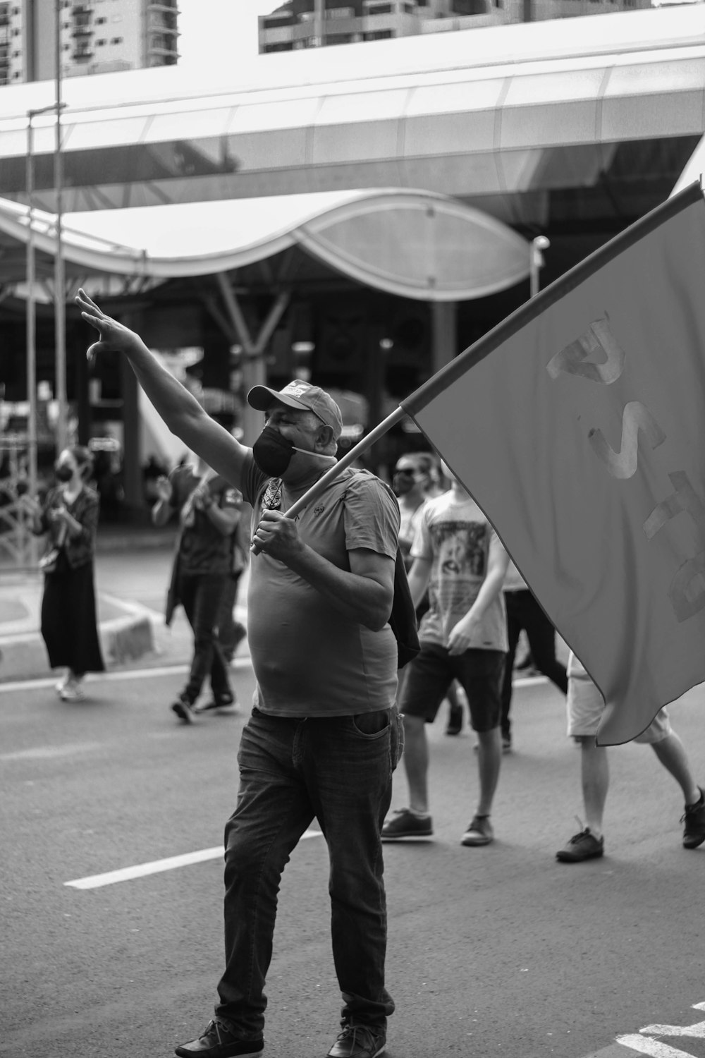 man in black t-shirt and black pants holding black flag