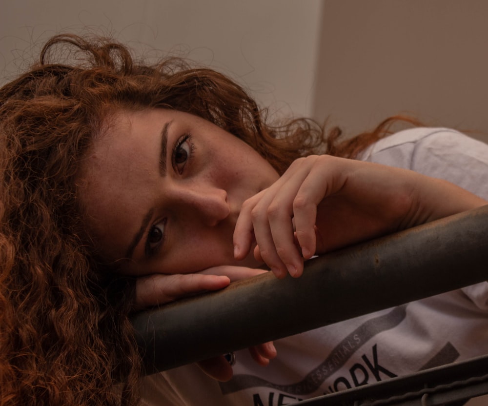 girl in white shirt lying on bed