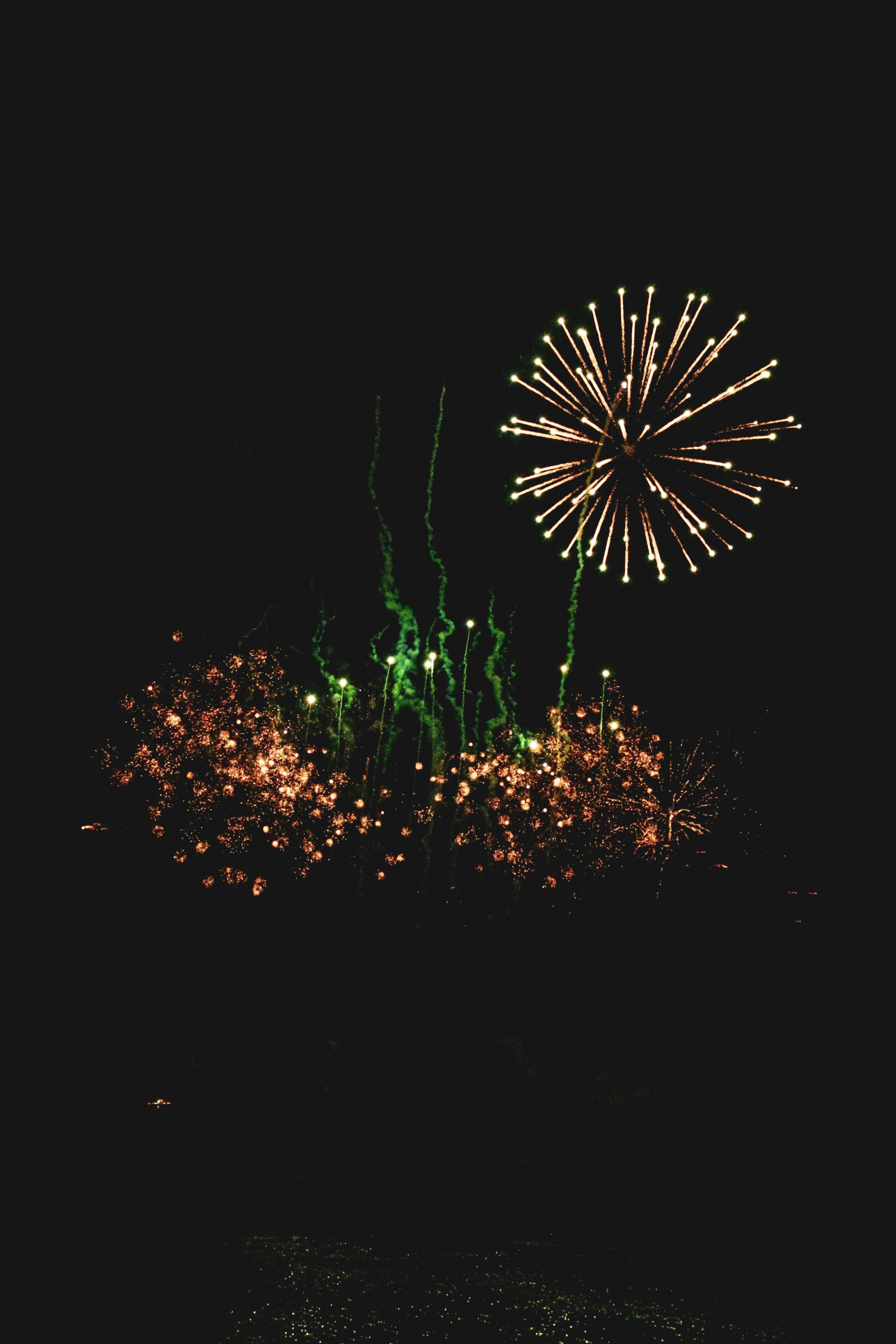 green and orange fireworks display