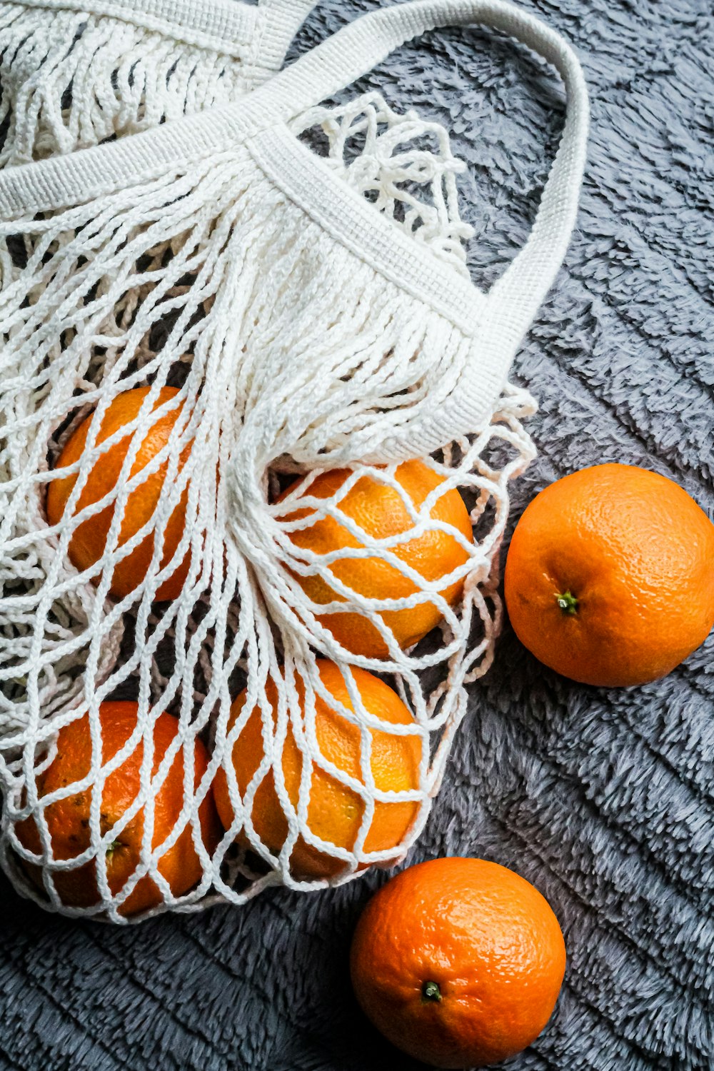 orange fruits on gray knit textile