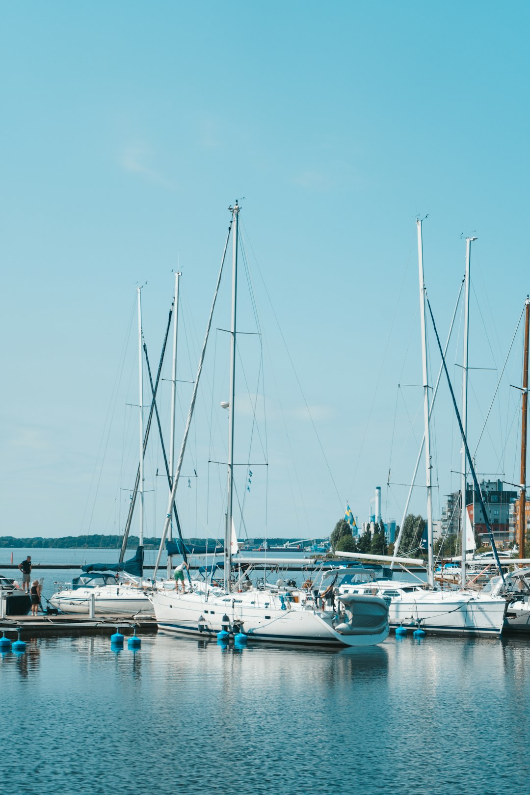 white and blue boats on sea during daytime