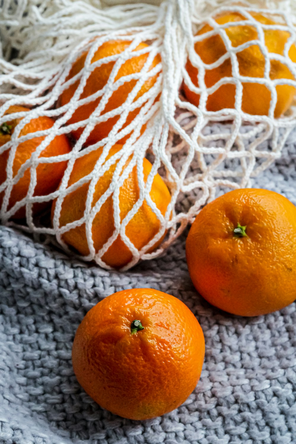 orange fruit on white knit textile