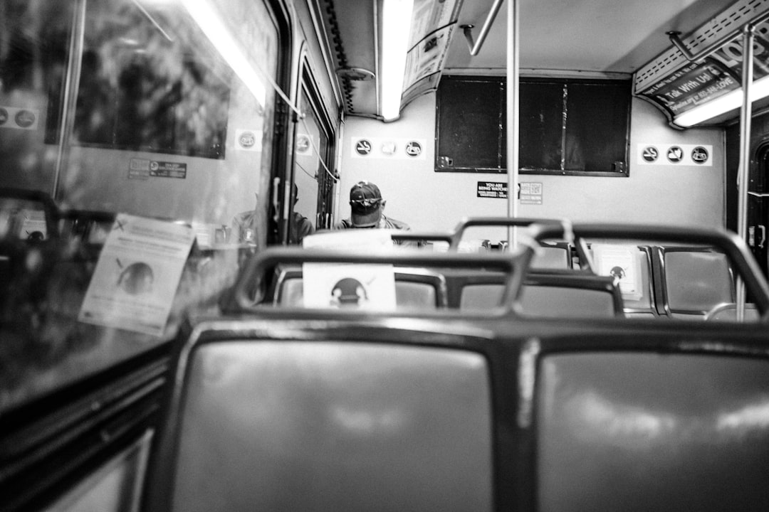 grayscale photo of people in train