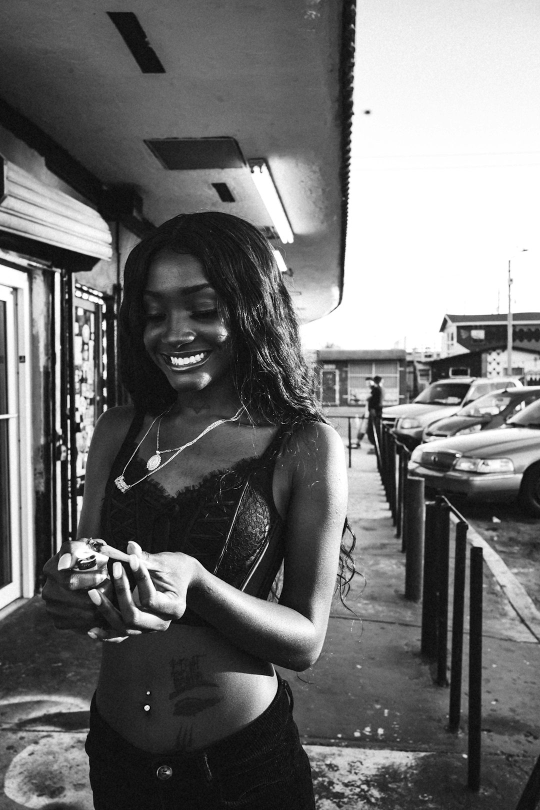 woman in spaghetti strap top holding a camera