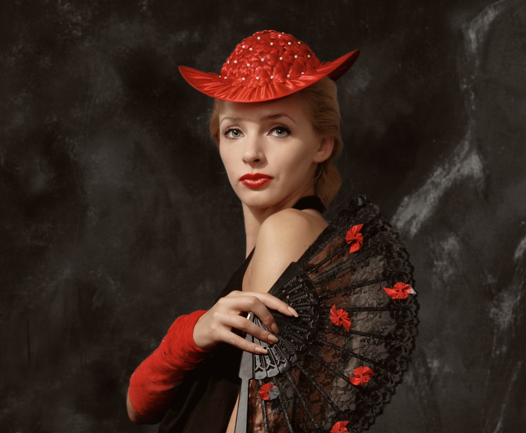 woman in red hat and black dress