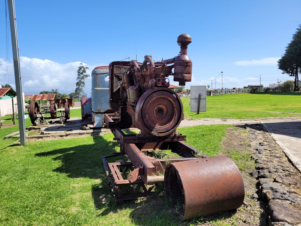 brown and black tractor on green grass field during daytime