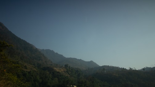A serene Himalayan landscape with lush greenery and mountains.
