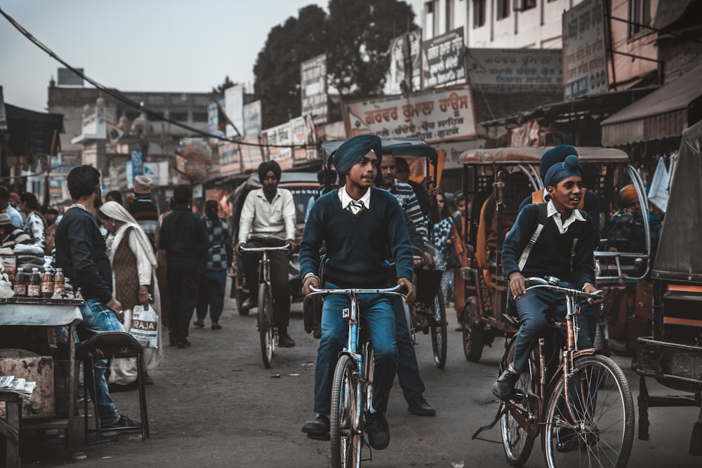 people riding bicycles on road during daytime