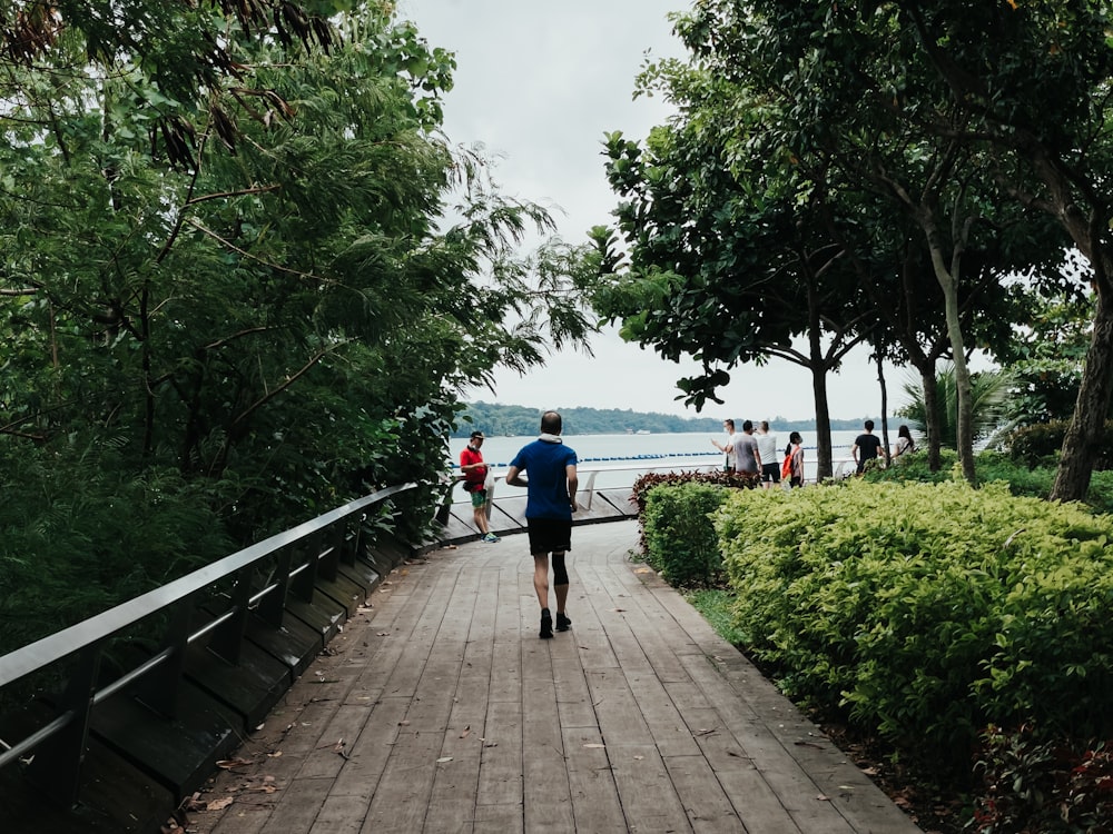 people walking on wooden pathway during daytime