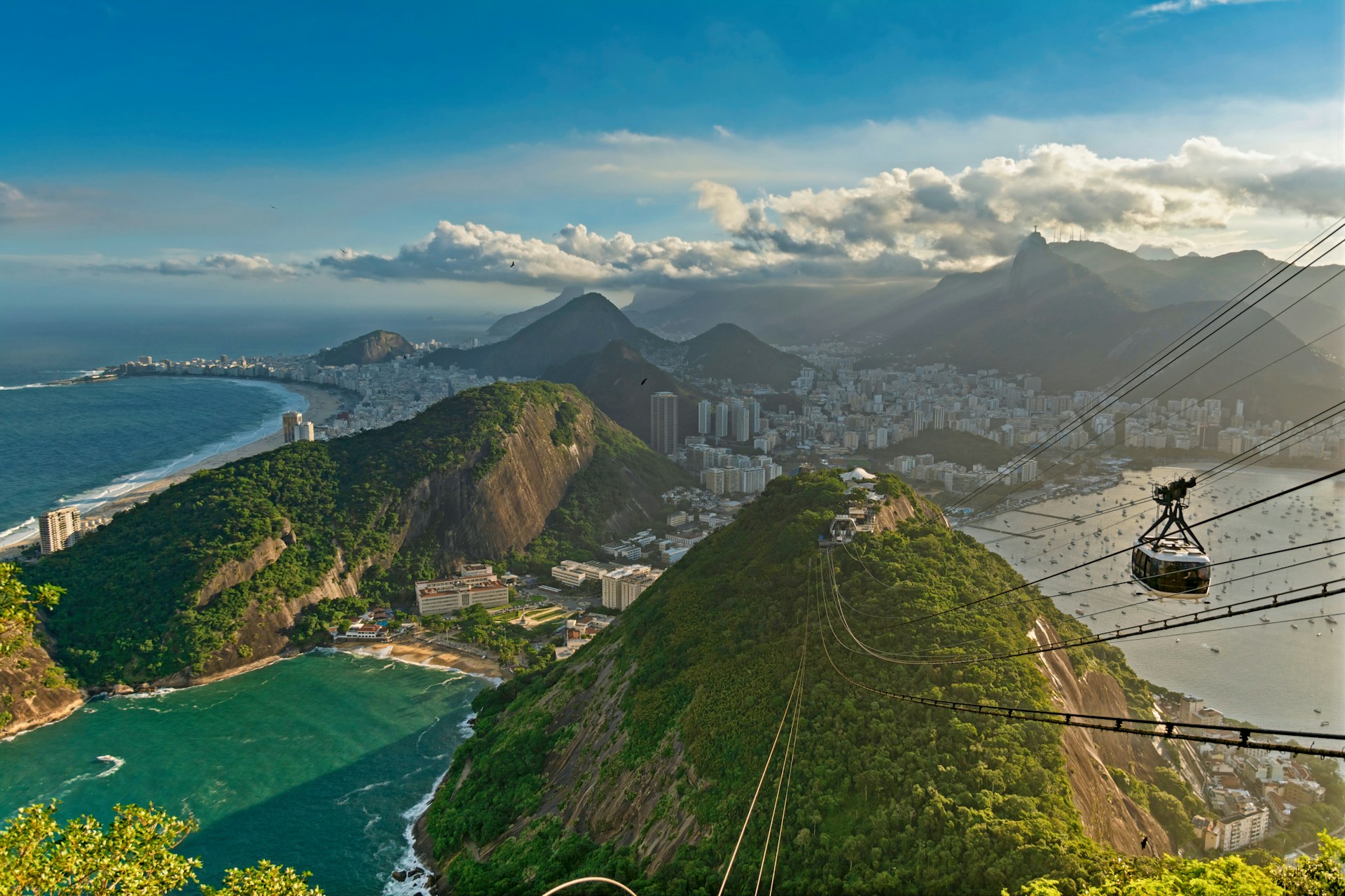 green and brown mountains near body of water during daytime