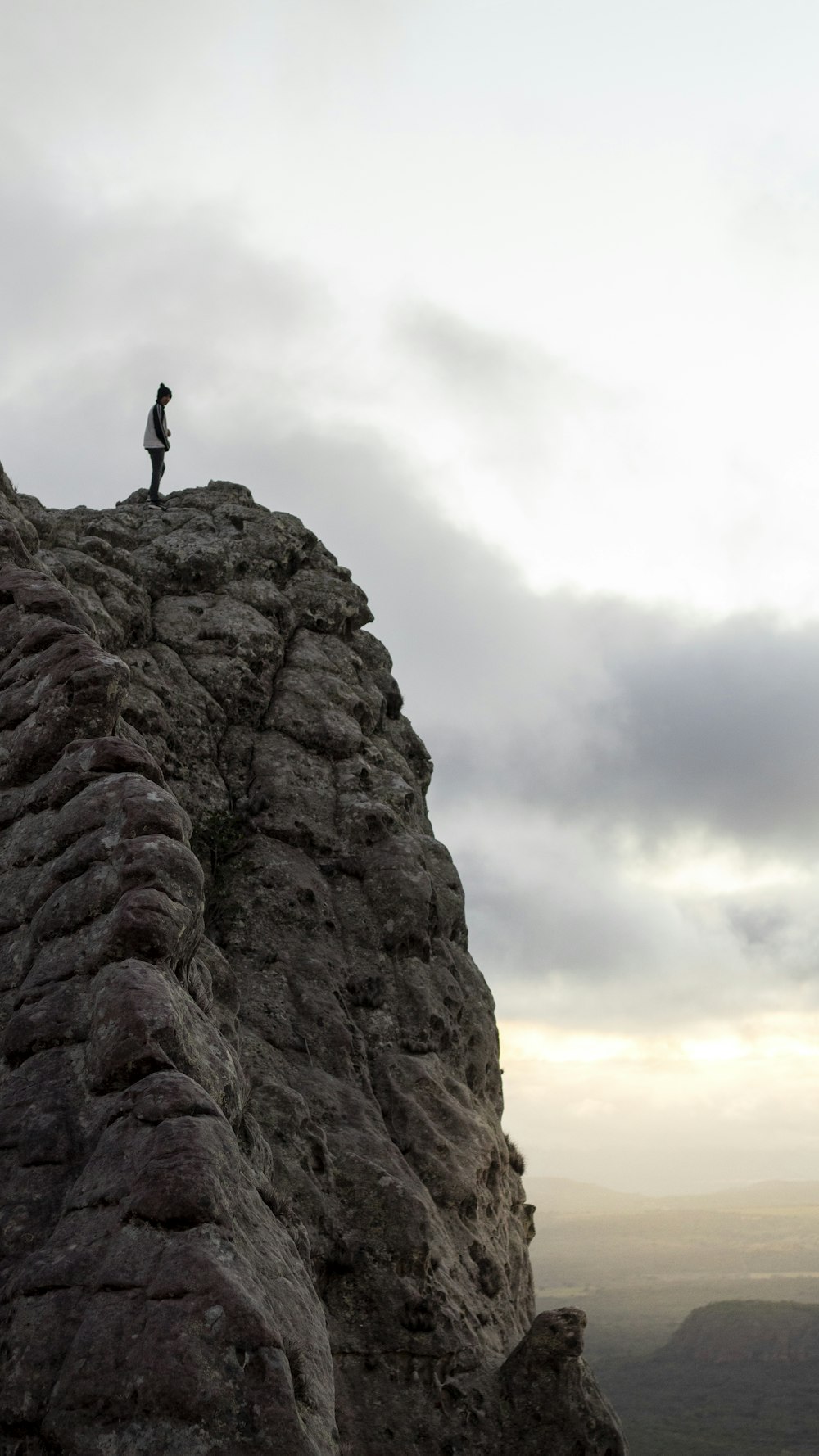 person standing on rock formation during daytime