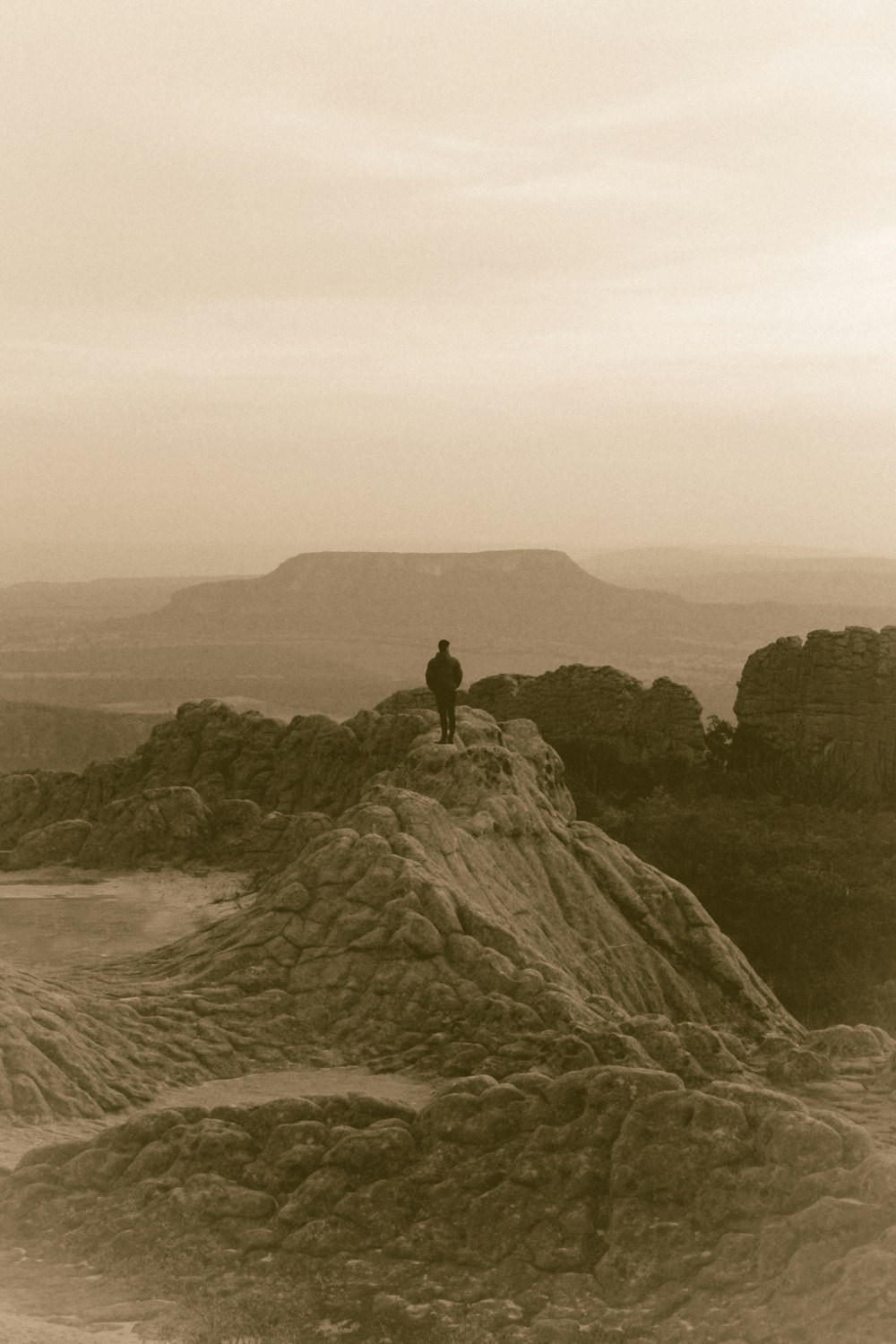 person standing on rock formation during daytime