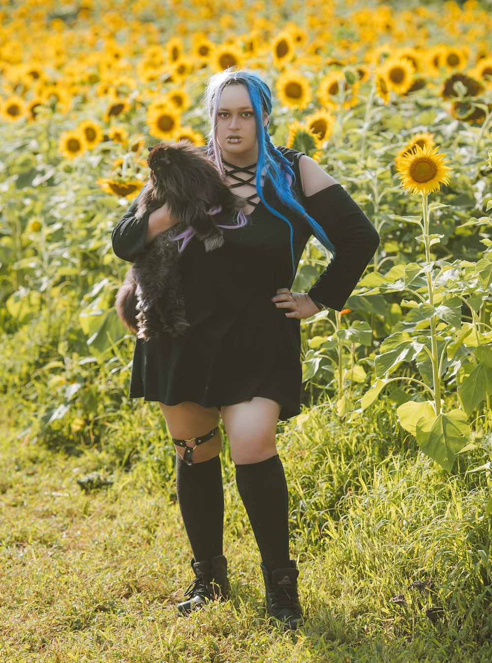 woman in black long sleeve dress standing on green grass field during daytime