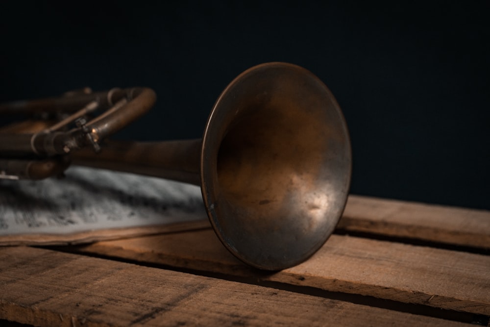 brass round ornament on brown wooden table